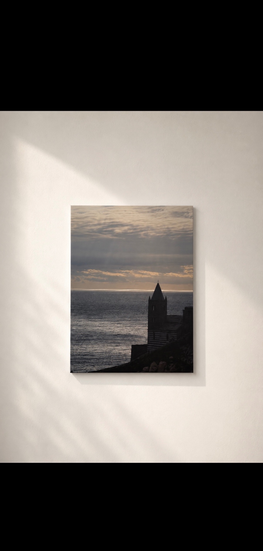 Photograph of the Portovenere church at sunset over the sea