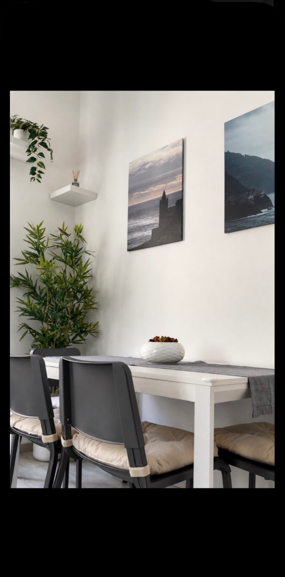Wooden dining table against deep blue wall at BLUVIA RESIDENCES