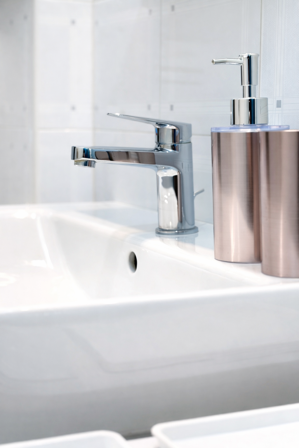 Bathroom detail with chrome faucet and amenities